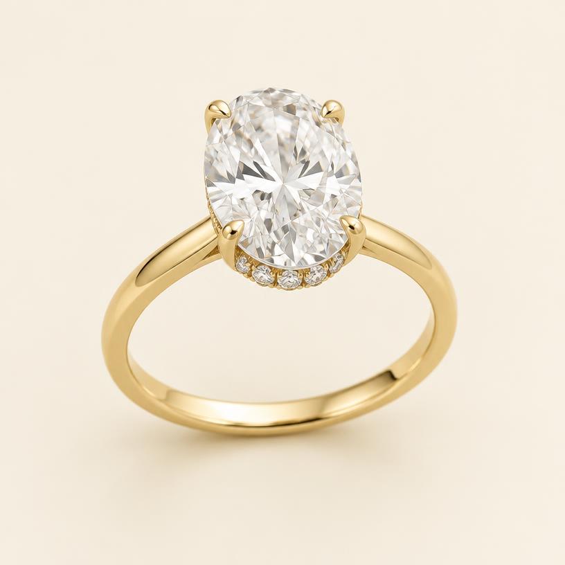 Three-quarter view of the yellow gold oval ring with hidden halo