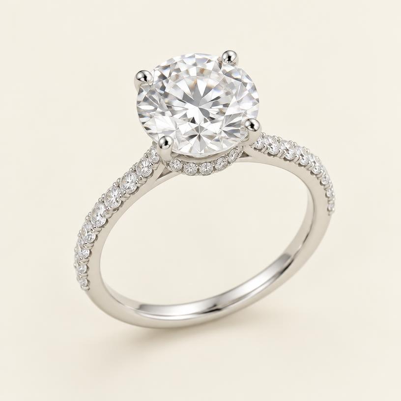 Three-quarter view of the platinum round ring with hidden halo and pavé band