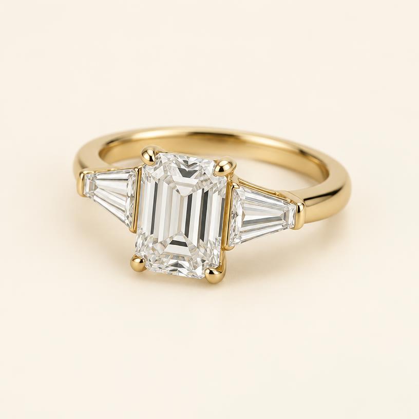 Three-quarter view of the yellow gold emerald-cut ring with tapered baguettes