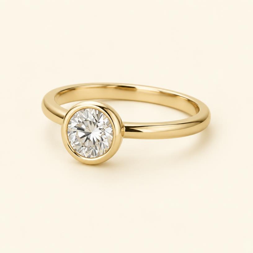 Three-quarter view of the yellow gold round bezel ring