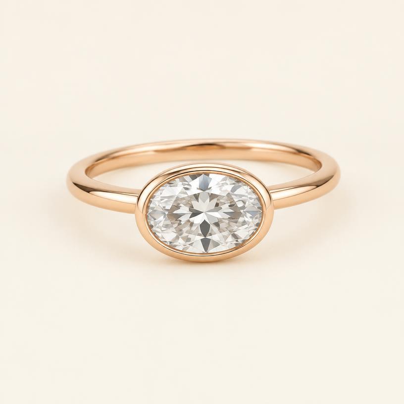 Three-quarter view of the rose gold east-west oval bezel ring